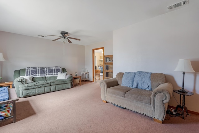 carpeted living room featuring ceiling fan