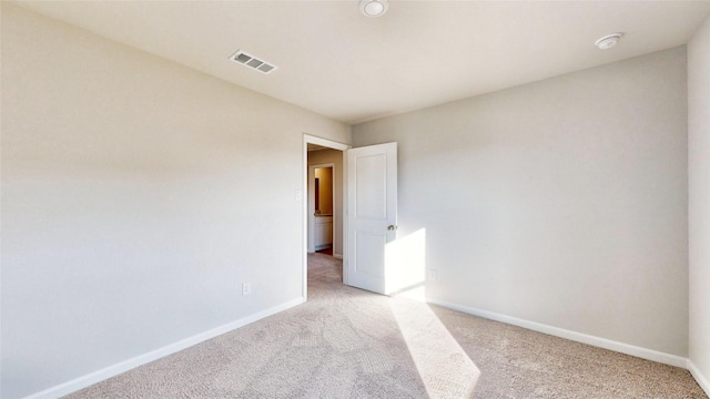 unfurnished room with light colored carpet