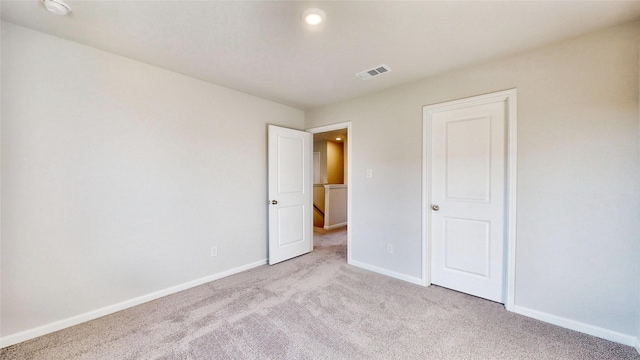 unfurnished bedroom featuring light carpet