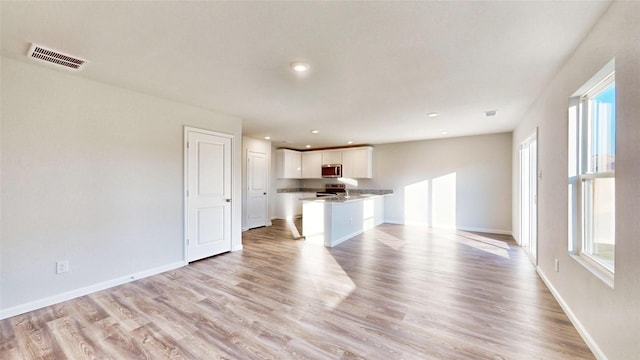 unfurnished living room featuring light wood-type flooring