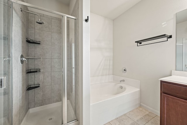 bathroom featuring plus walk in shower, vanity, and tile patterned flooring