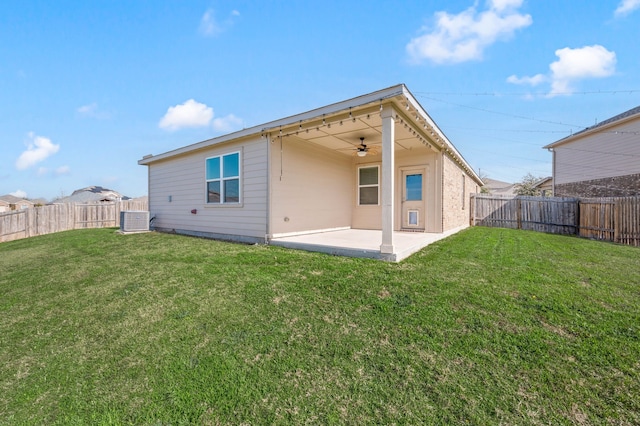 back of house featuring ceiling fan, a patio area, cooling unit, and a yard