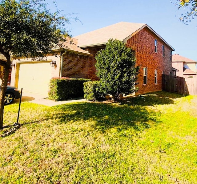 view of front facade with driveway, brick siding, a front lawn, and fence