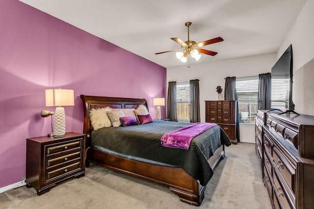 bedroom featuring light carpet, ceiling fan, and baseboards