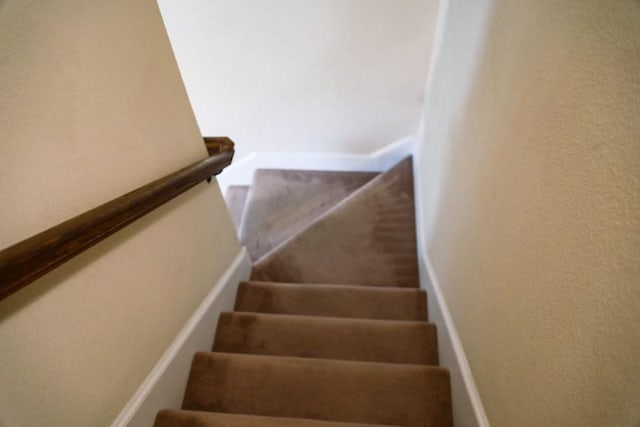 stairway featuring a textured wall