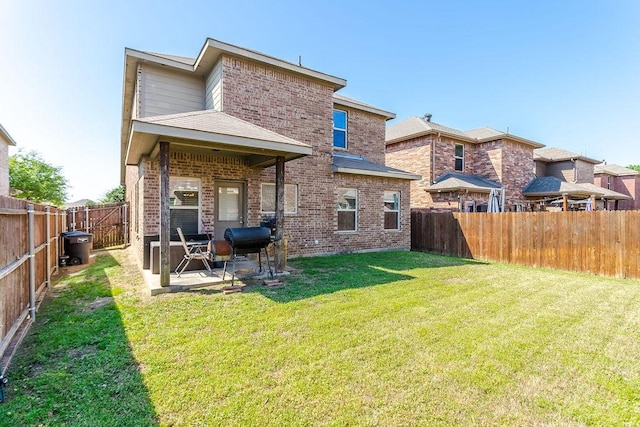 back of house featuring brick siding and a patio