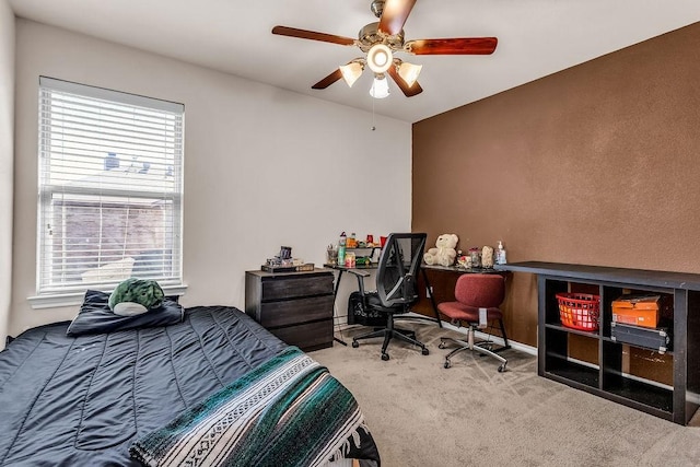 carpeted bedroom featuring multiple windows and ceiling fan