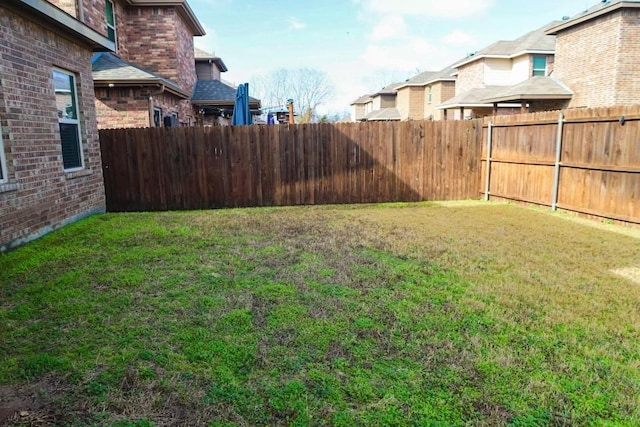 view of yard with a fenced backyard