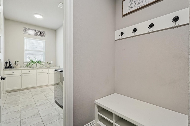 mudroom with washer / dryer and light tile patterned flooring