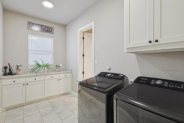 washroom featuring cabinets, light tile patterned floors, and independent washer and dryer