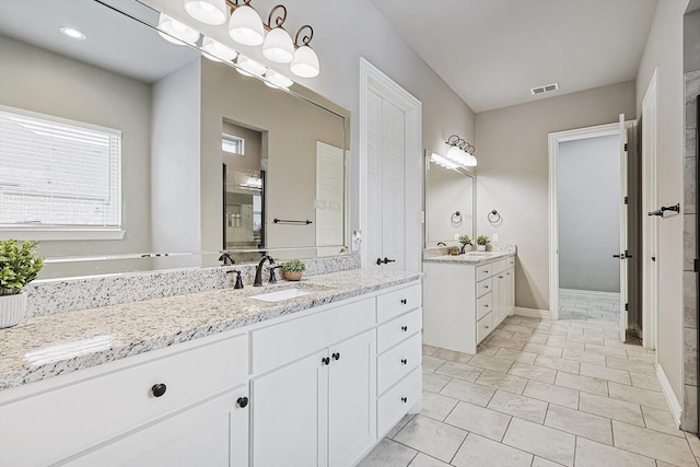 bathroom with tile patterned floors and vanity