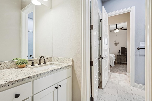 bathroom featuring ceiling fan, vanity, and tile patterned flooring