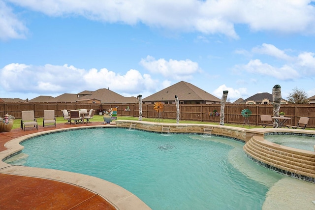 view of swimming pool featuring pool water feature and an in ground hot tub