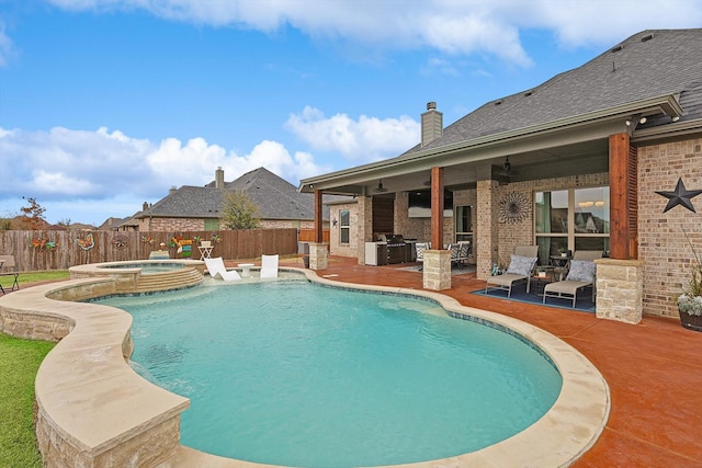 view of pool with exterior kitchen, a patio area, and an in ground hot tub