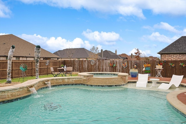 view of pool featuring pool water feature and an in ground hot tub