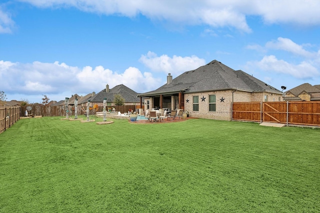 back of house featuring a yard and a patio