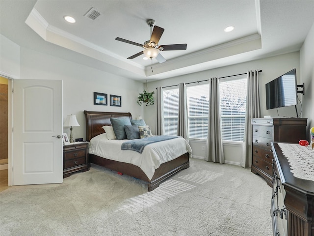 bedroom featuring ceiling fan, light colored carpet, a tray ceiling, and ornamental molding