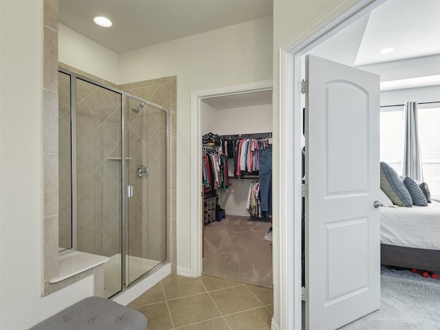 bathroom featuring a shower with shower door and tile patterned flooring