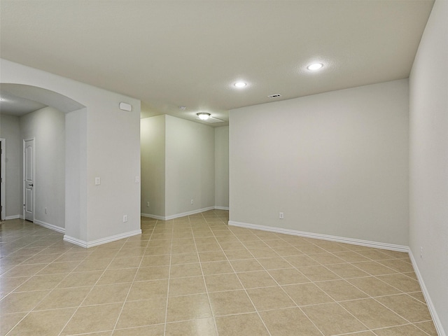 2337 Brookdale Dr, Frisco, TX 75036 - spare room featuring arched walkways, recessed lighting, and light tile patterned floors
