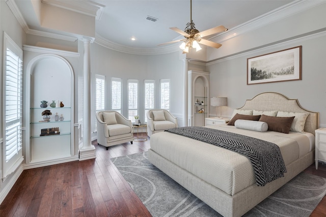 bedroom with decorative columns, ceiling fan, ornamental molding, and dark hardwood / wood-style flooring