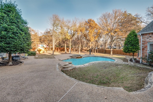 view of swimming pool with a playground, an in ground hot tub, and a patio