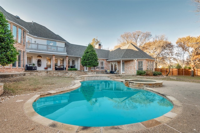 view of swimming pool featuring an in ground hot tub and a patio area