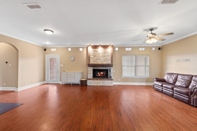 unfurnished living room with ceiling fan, crown molding, a fireplace, and wood-type flooring