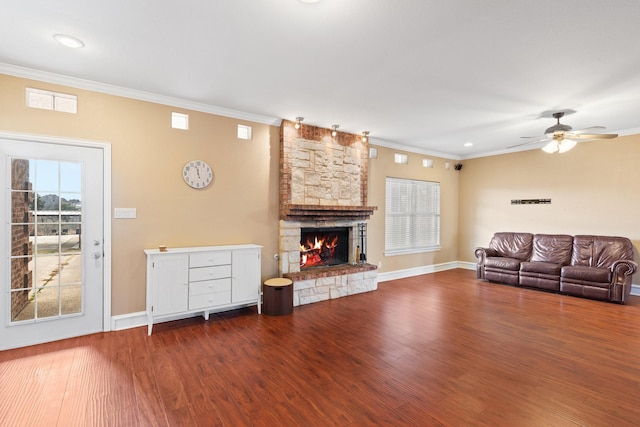 unfurnished living room with crown molding, a fireplace, ceiling fan, and hardwood / wood-style flooring