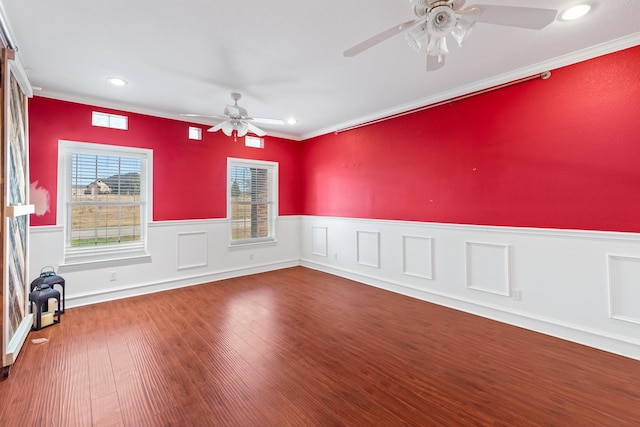 empty room with hardwood / wood-style flooring, ornamental molding, and ceiling fan