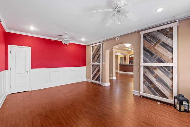 empty room featuring crown molding, ceiling fan, and hardwood / wood-style floors