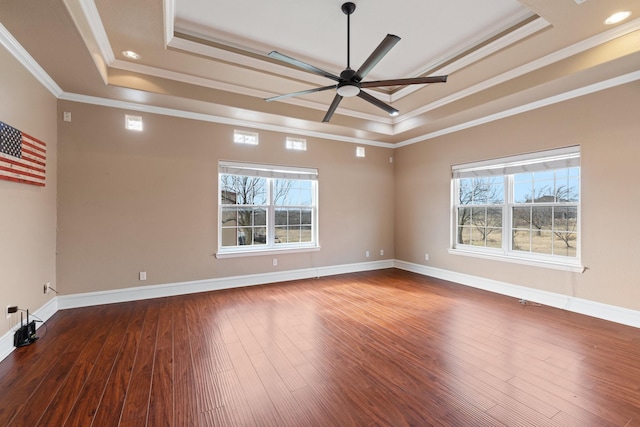 spare room with ceiling fan, ornamental molding, a raised ceiling, and hardwood / wood-style floors