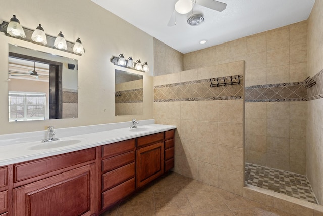 bathroom featuring vanity, tile patterned flooring, ceiling fan, and tiled shower