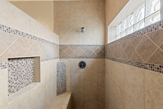 bathroom with a tile shower