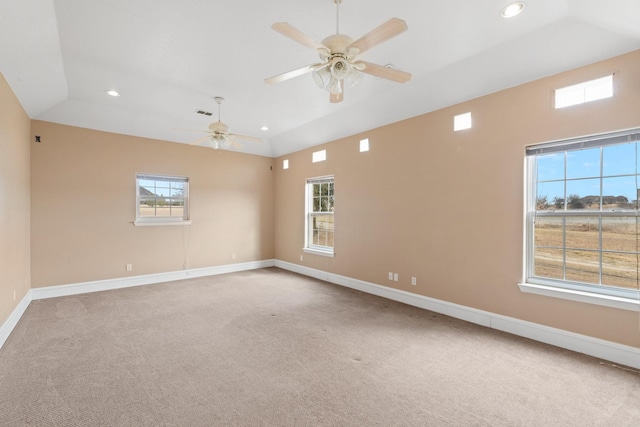 spare room with vaulted ceiling, ceiling fan, and carpet