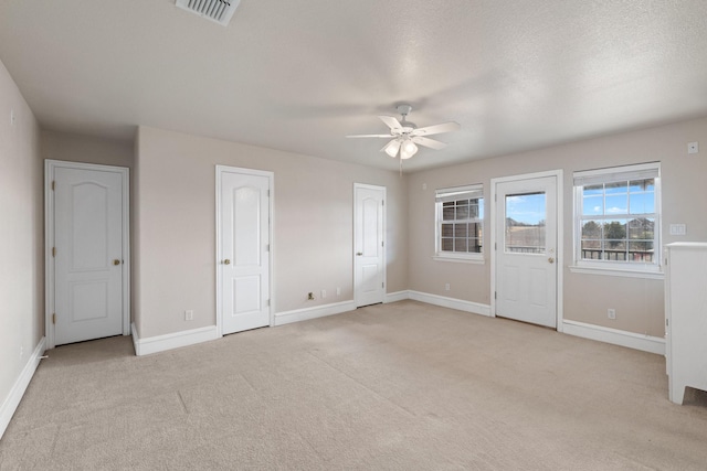 interior space with light colored carpet and ceiling fan