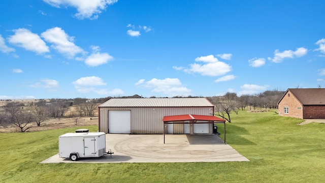 back of house featuring a yard, a garage, an outdoor structure, and a carport