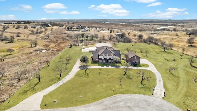 birds eye view of property with a rural view