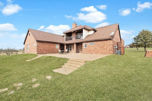 rear view of property featuring a balcony, a lawn, a patio, and central air condition unit