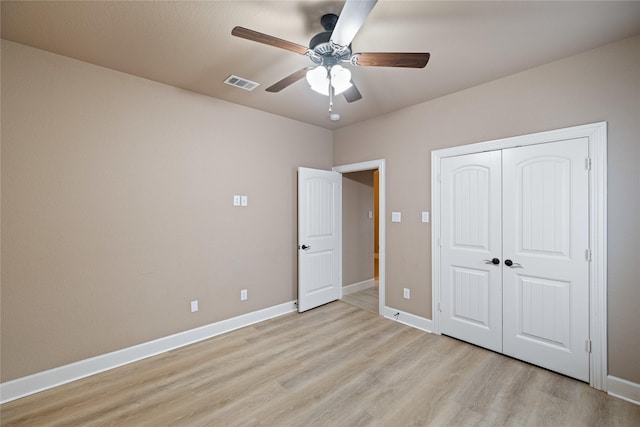 unfurnished bedroom featuring light wood-type flooring, ceiling fan, and a closet