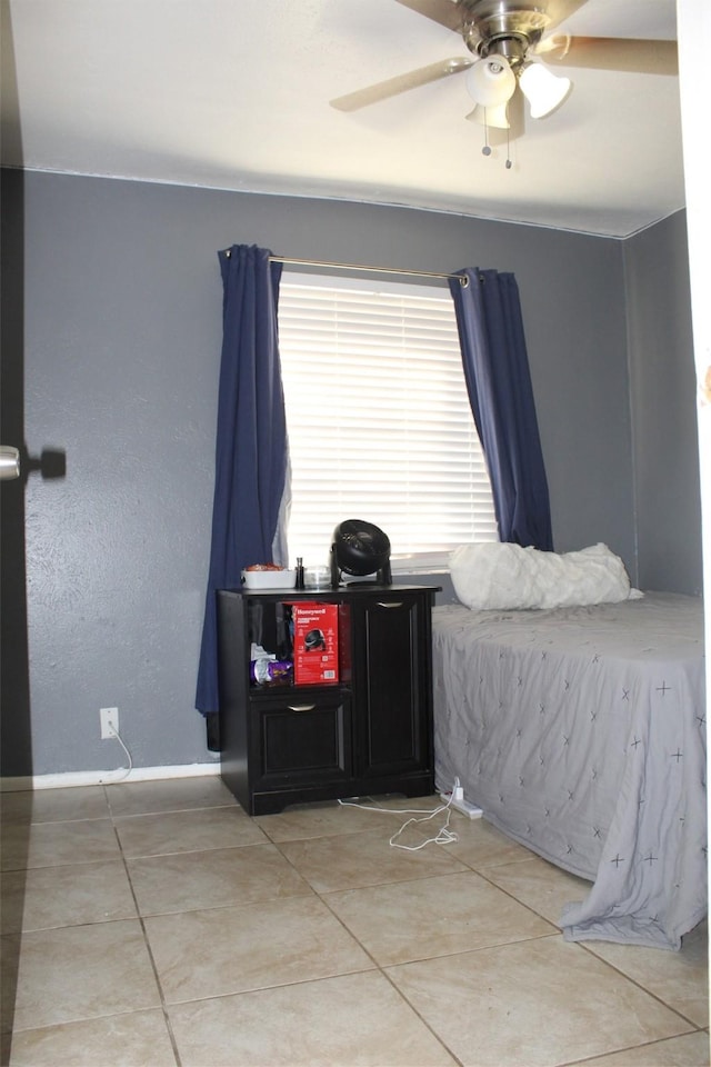 tiled bedroom featuring ceiling fan