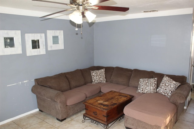 living room with light tile patterned floors, visible vents, and a ceiling fan