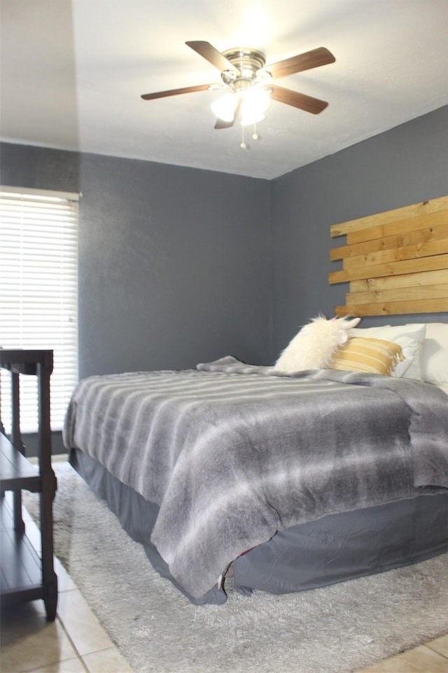 bedroom with light tile patterned flooring and a ceiling fan