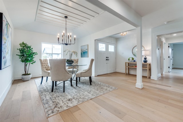 dining area featuring an inviting chandelier and light hardwood / wood-style floors