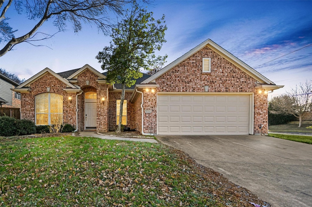 view of property with a lawn and a garage