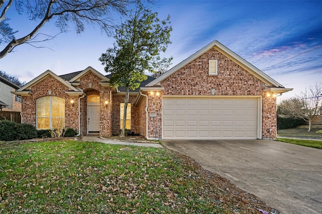 view of property with a lawn and a garage