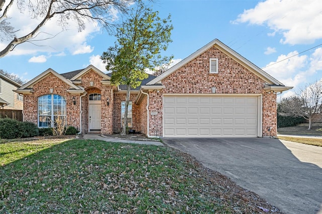 view of property featuring a garage and a front yard