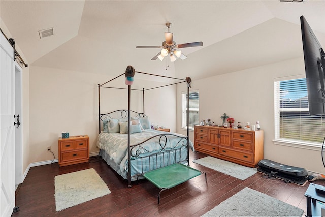 bedroom featuring dark wood-type flooring, ceiling fan, a barn door, and vaulted ceiling