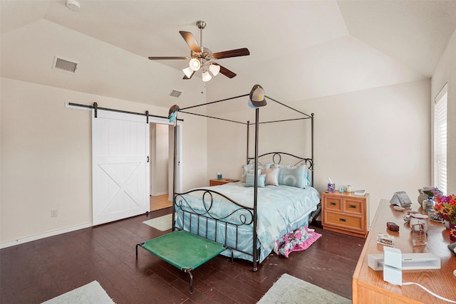 bedroom with a barn door, dark wood-type flooring, lofted ceiling, and ceiling fan