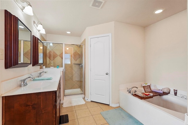 bathroom with tile patterned floors, shower with separate bathtub, and vanity