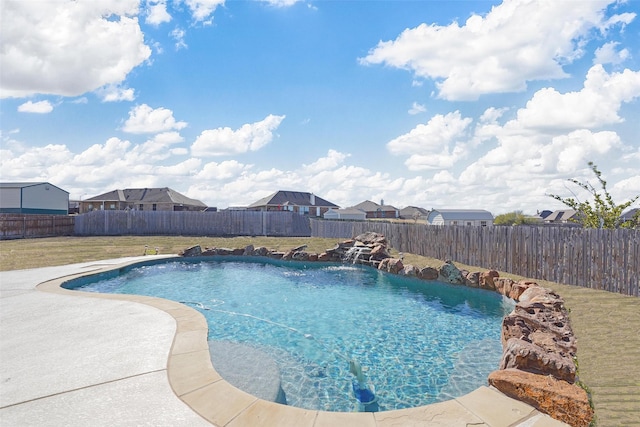 view of swimming pool featuring pool water feature and a yard